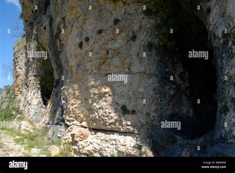 Two Cave Entrances In Limestone Cliff Vall De Laguart Benimaurell