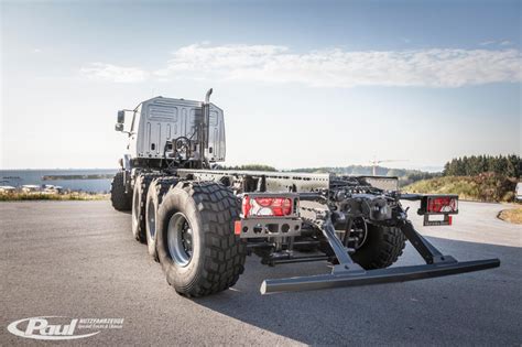 The Large Truck Is Parked On The Side Of The Road