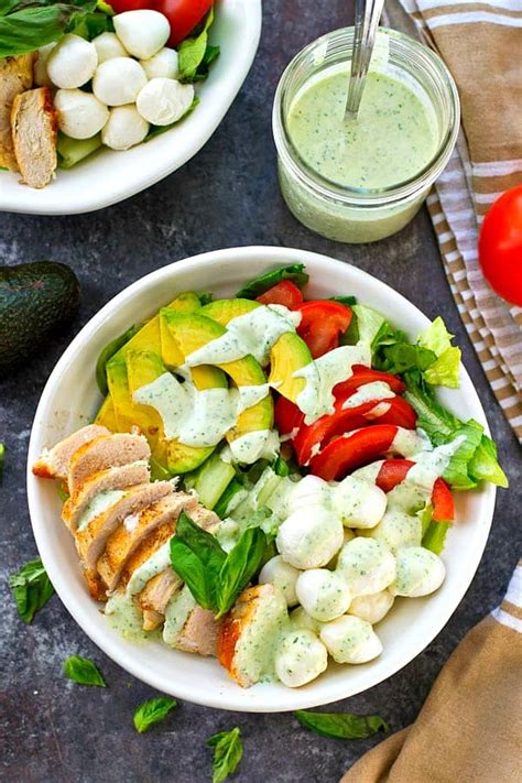 Slice the chicken into strips and prepare the salad. Chicken Avocado Caprese Salad with Creamy Pesto Dressing