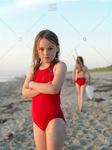 Girl Standing On Sandy Beach Stock Photo Offset