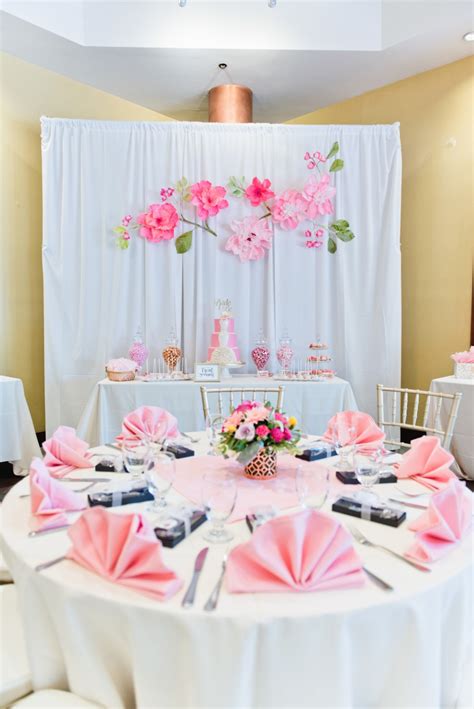 Decorate your table with hot pink placemats or a gold tablecloth, go for wicker placemats, for fans as favors and escort cards, colorful glasses, colorful candles a bright tropical bridal shower table setting with pineapples with bright florals and pink flamingos, yellow glasses and plates and printed napkins. How To Throw A Posh Princess Bridal Shower!