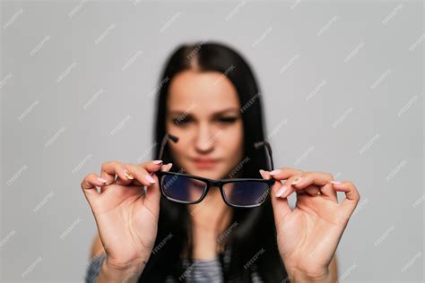 Premium Photo Eyeglasses Closeup Spectacles In Womans Hands Looking