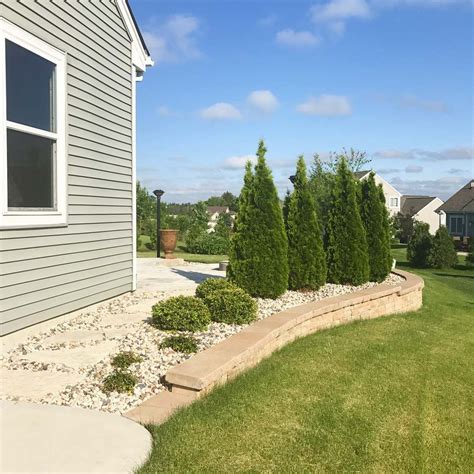 A Retaining Wall We Finished Earlier This Spring The Arborvitaes