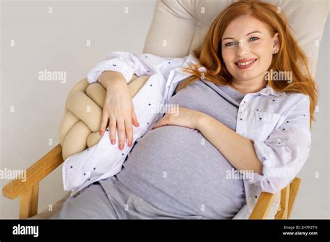 Top View Happy Young Redhead Pregnant Woman Lying On Comfortable