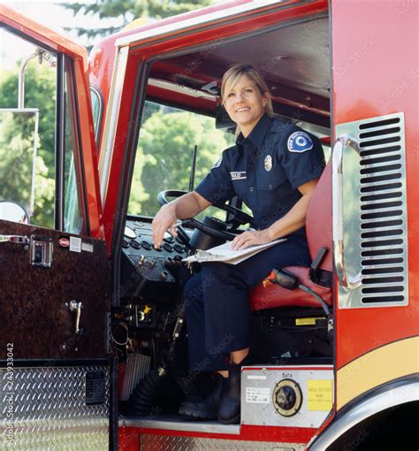 Smiling Female Woman Firefighter Sitting In Driver S Seat Of Fire