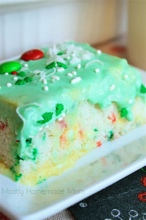 Cake with jello drizzles poked throughout, and topped with a smooth layer of whipped cream! Christmas Coconut Poke Cake | Mostly Homemade Mom