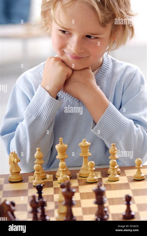 Portrait Of Smiling Little Boy Playing Chess Stock Photo Alamy
