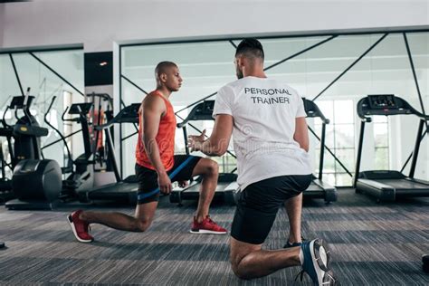 Back View Of Personal Trainer Instructing Stock Photo Image Of Sporty