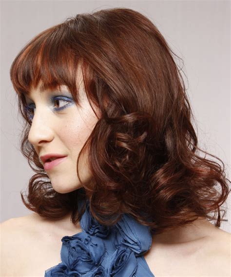 However, within these hues, women can ask their stylists to create colors that come off as rich, warm, cool, and vibrant. Medium Wavy Auburn Brunette Hairstyle with Layered Bangs