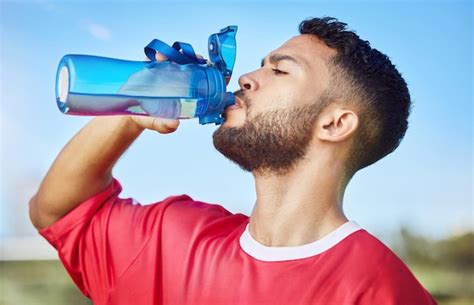 Premium Photo Man Soccer And Hydration Drinking Water For Sports