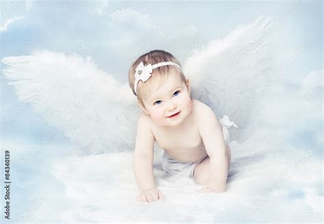 Baby Angel Wings Angelic Cupid Kid Child At Blue Sky Cloud Stock