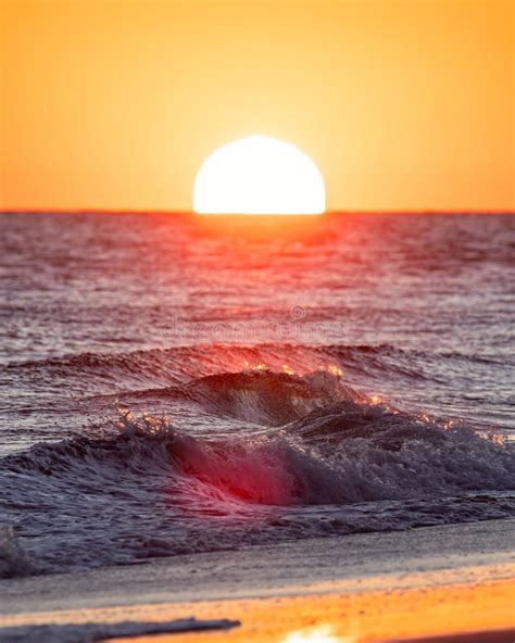 Beautiful Sunset Over The Ocean As The Sun Dips Below The Horizon Stock