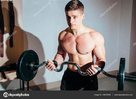 Muscular Man Working Out In Gym Doing Exercises With Barbell Strong Male Naked Torso Abs