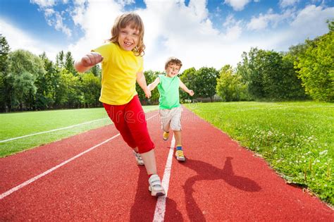 Two Children Holding Hands Running Together Stock Photo Image Of Cute