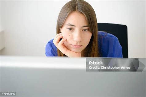 Bored Young Office Woman Staring At Computer Screen Stock Photo
