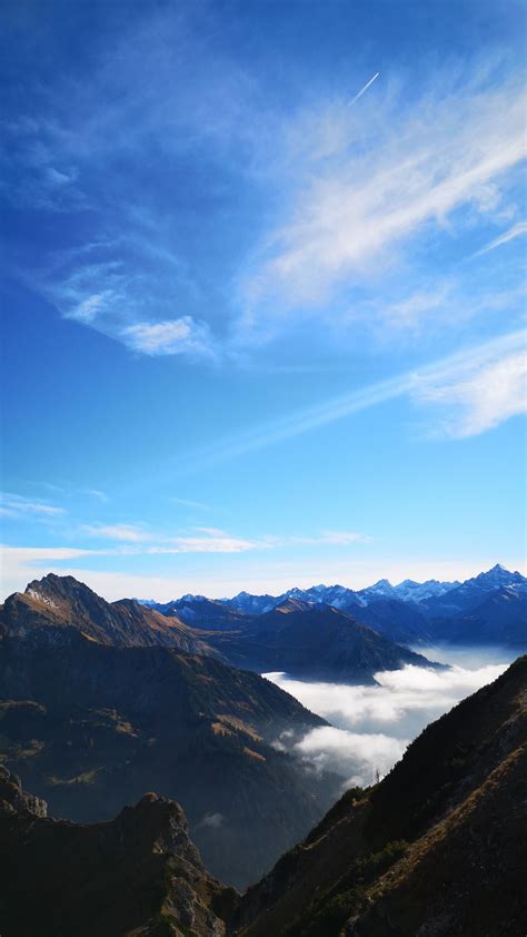 Download Wallpaper 1350x2400 Mountains Peaks Aerial View Fog Clouds