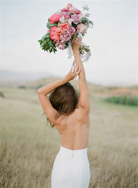 Back Of Topless Bride Holding Pink Peony And Lavender Rose Bouquet