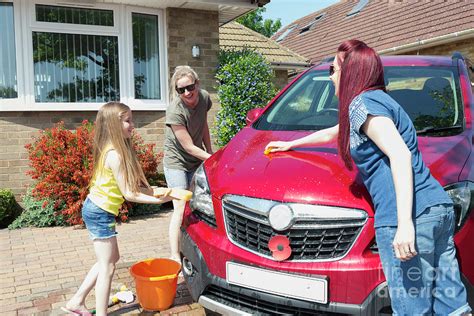 Lesbian Couple And Daughter Washing Car Photograph By Caia Imagescience Photo Library