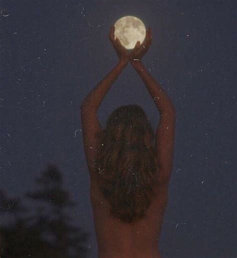 A Naked Woman Holding Up A Full Moon In The Night Sky With Her Hands