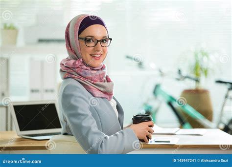 Beautiful Stylish Woman In Hijab And Eyeglasses Sitting At Desk With