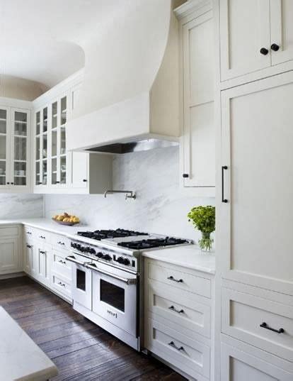 These silver circular knobs on these white shaker cabinet doors is a more traditional appearance and is often found in bathroom cabinet doors for its clean look. white cabinets dark floor black handles - Google Search ...