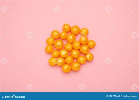Sweet Yellow Candies On A Pink Background Round Sweet Food Stock Image