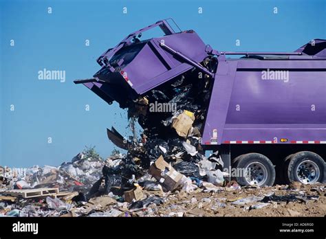 A Large Garbage Truck Dumps Trash At A Landfill Stock Photo Alamy