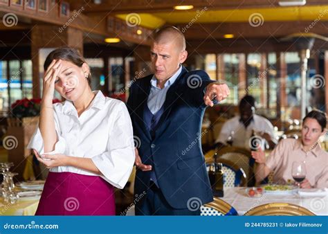 Angry Man Client Of Restaurant Yelling At Young Waitress Stock Image