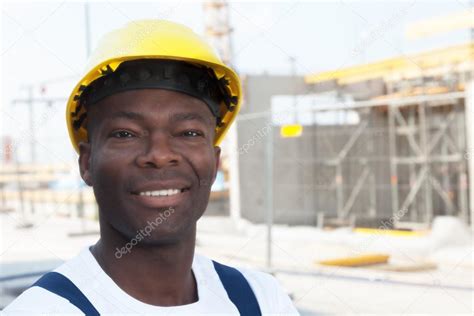 Happy African American Construction Worker At Building Site Stock Photo