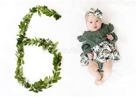 6 Month Old Baby Girl In A Green Dress Baby Milestone Six Months