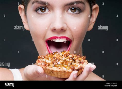 Woman Eating A Tart And Smiling Stock Photo Alamy