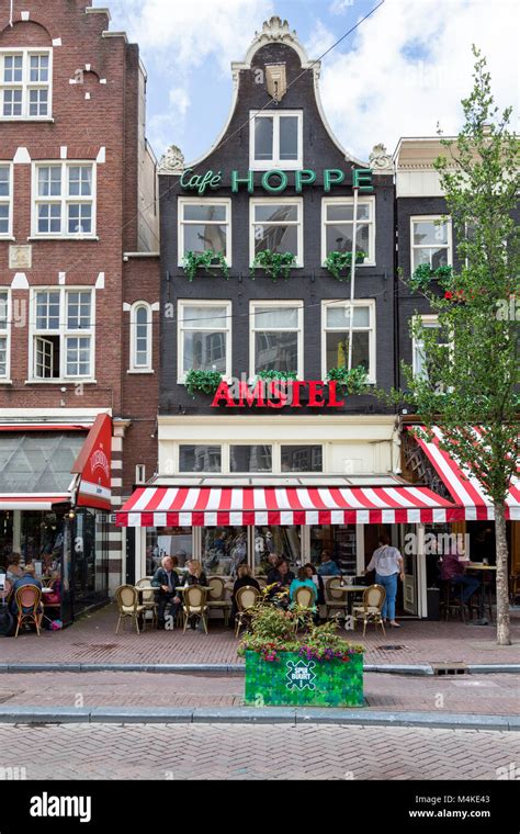 Cafe In Amsterdam With Outdoor Dining Covered Patio With Red And White