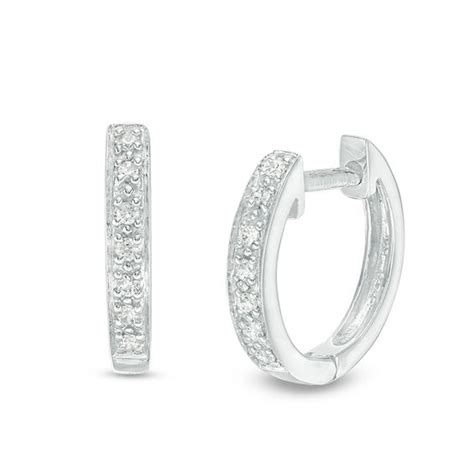 It weighs 1.8 pennyweights and is 14k white gold. 1/20 CT. T.W. Diamond Huggie Hoop Earrings in 14K White Gold | Gordon's Jewelers