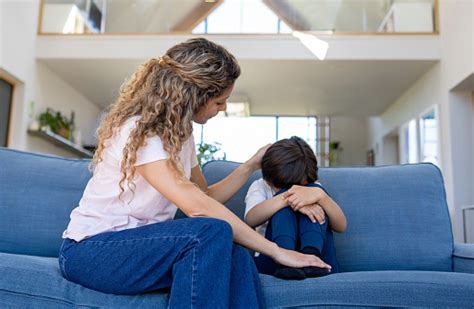 Loving Mother Comforting Her Sad Son At Home Stock Photo Download
