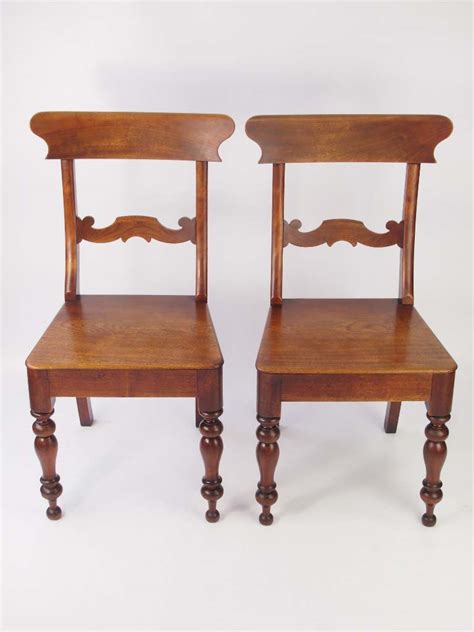 Georgian antique chairs were made from thick mahogany with intricate engravings of natural motifs including swirls, leaves and shells. Pair Antique Victorian Kitchen Chairs