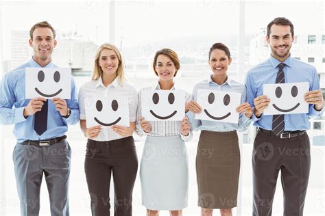 Business People Holding Happy Smileys In Office 906077 Stock Photo At