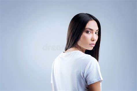 Shy Quiet Student Turning Her Head While Standing Alone Stock Photo