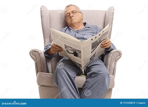 Elderly Man With A Newspaper Sleeping In An Armchair Stock Image