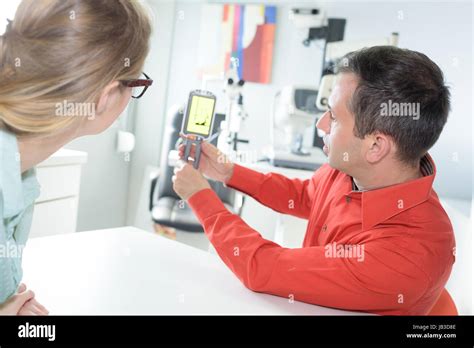 medical salesman showing device to doctor Stock Photo - Alamy