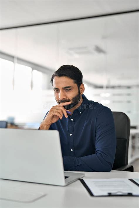 Young Indian Business Man Talking Having Virtual Meeting Working On