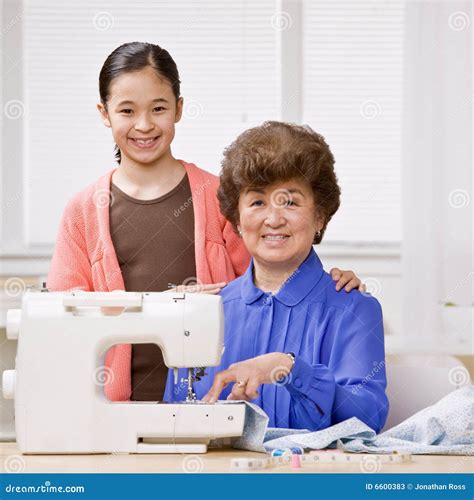 Granddaughter And Grandmother Use Sewing Machine Stock Image Image Of Cooperation Looking