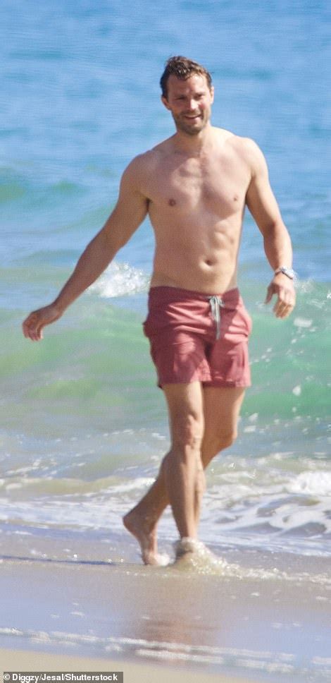 Jamie Dornan Shows Off His Fit Physique As He Whips Off His Top And