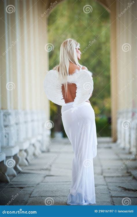 Blonde Angel With White Light Wings And White Veil Posing Outdoor Stock