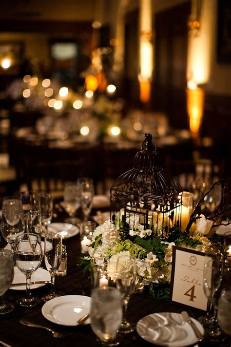 Gold paper tablecloths with a lovely linen feel for your golden wedding anniversary party tables. Reception table setting details - Black tablecloth, white ...
