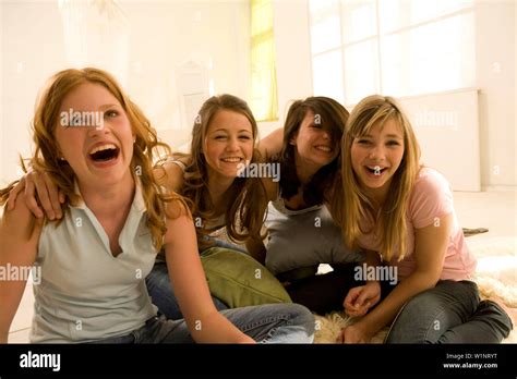 Four Teenage Girls 14 16 Having Fun Sitting On Floor Indoor Stock