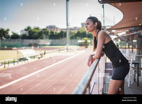 Young Woman Leaning On Railing By Race Track Stock Photo 73168294 Alamy