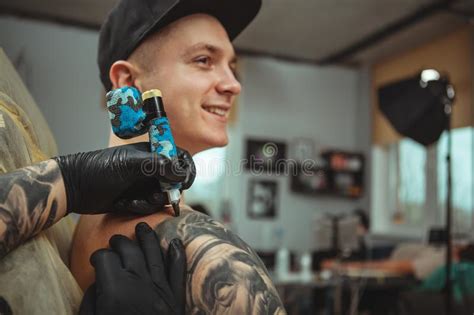 Handsome Man Getting A Tattoo At Alternative Art Studio Stock Image