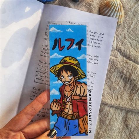 Someone Is Holding Up A Bookmark With An Image Of One Piece Of The Same