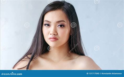 Medium Close Up Portrait Confident Naked Asian Woman With Windy Hair Looking At Camera Slow