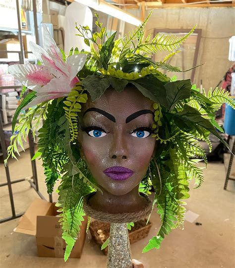 Styrofoam mannequin head painted to look like a garden goddess